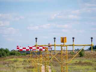 Fototapeta na wymiar Yellow metal support systems of care during takeoff and landing direction light near runway