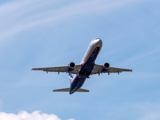 MOSCOW , RUSSIA, June 10, 2019: The Commercial passenger airplane flying overhead on sunny day on June 10, 2019 in Moscow, Russia