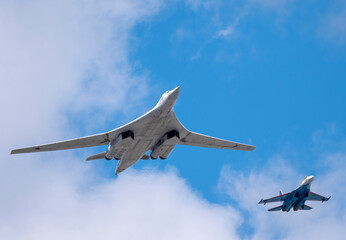 MOSCOW, RUSSIA - MAY 7, 2021: Avia parade in Moscow. su-35 and strategic bomber and missile platform Tu-160 in the sky on parade of Victory in World War II in Moscow, Russia