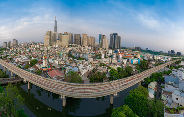 Obraz premium Beautiful aerial view at night in Ho Chi Minh City, see the Landmark 81 tower, the tallest tower in Vietnam. Subway track tracks below. Travel concept