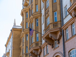 Wrapped around flagpole flag of the USA in Russia Moscow