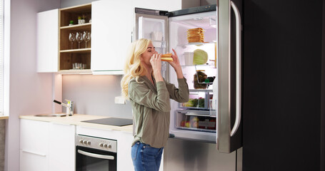 Young Woman Eating Sandwich In Front