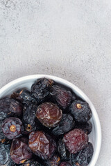 Raw Organic Arabic Dates, Ajwa Dates on light gray background. Ramadan Kareem. Close up.