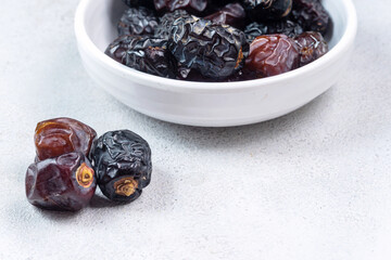 Raw Organic Arabic Dates, Ajwa Dates on light gray background. Ramadan Kareem. Close up.