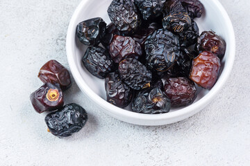 Raw Organic Arabic Dates, Ajwa Dates on light gray background. Ramadan Kareem. Close up.