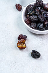 Raw Organic Arabic Dates, Ajwa Dates on light gray background. Ramadan Kareem. Close up.