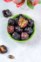 Raw Organic Arabic Dates, Ajwa Dates on light gray background. Ramadan Kareem. Top View.