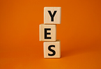 Yes symbol. Wooden blocks with word yes. Beautiful orange background. Business and yes concept. Copy space.
