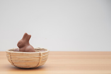 Chocolate bunny and chocolate eggs on a wooden table. Easter background.