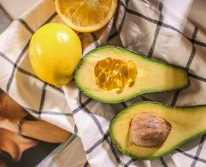 In a basket of healthy and sports nutrition lie omega 3 fish oil tablets, orange, yellow lemon and...