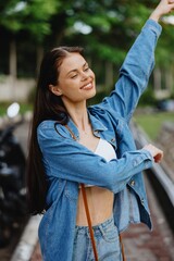 Portrait of a woman brunette smile with teeth walking outside against a backdrop of palm trees in the tropics, summer vacations and outdoor recreation, the carefree lifestyle of a freelance student.