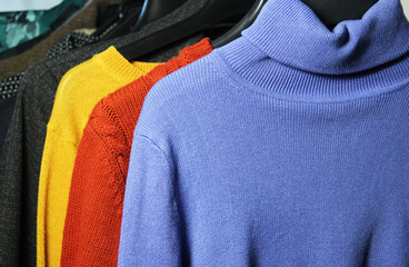 Mix of vivid multicoloured knitwear in the dressing room
