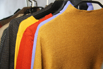 Mix of vivid multicoloured knitwear in the dressing room
