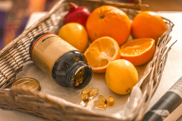 Healthy and sports nutrition basket contains omega 3 fish oil tablets, orange, yellow lemon and red grapefruit