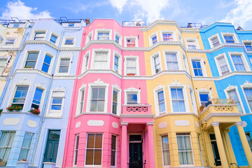 Colorful pastel houses of Notting Hill, London, England. Upward street view.