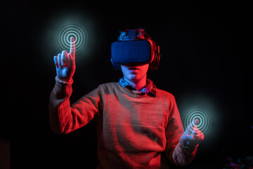 Young man pressing virtual points with VR headset and colorful lights