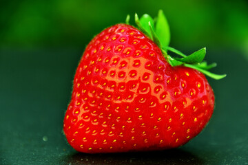 Close-up of a single ripe and red strawberry