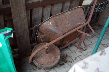 Overturned iron gardening wheel.