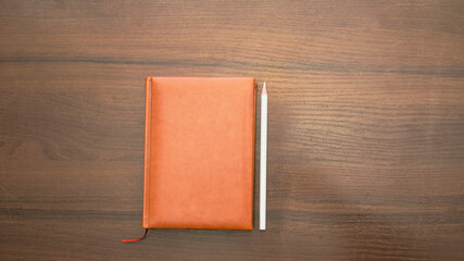 Notebook and pencil on a beautiful background in a photo studio