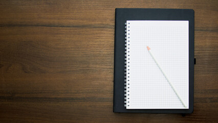 Notebook and pencil on a beautiful background in a photo studio
