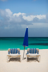 Des transats sur une plage tropicale en format vertical. 