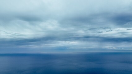 Naklejka na ściany i meble Aerial view of the aegean sea with drone on a cloudy day with a view of the island of Chios