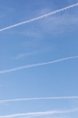 Spectacular chemtrails on a clear blue sky day, chemical trails from planes: a controversial topic