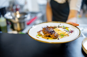 Chef cooking Roasted Duck breast fillets with vegetable pure on restaurant kitchen