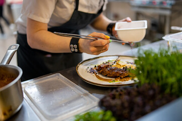 Chef cooking Roasted Duck breast fillets with vegetable pure on restaurant kitchen