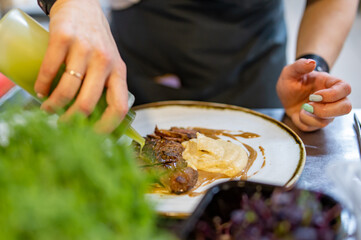 Chef cooking Roasted Duck breast fillets with vegetable pure on restaurant kitchen