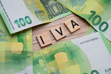 the inscription IVA or VAT in Italy next to euro banknotes. Concept showing value added tax