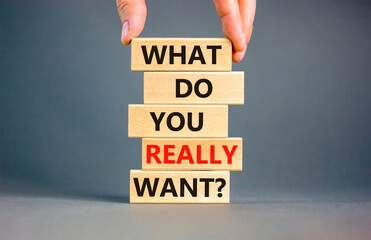 What do you really want symbol. Concept words What do you really want on wooden block. Beautiful grey table grey background. Businessman hand. Business and what do you really want concept. Copy space.