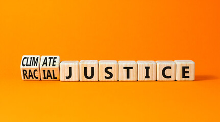 Climate or racial justice symbol. Concept words Climate justice Racial justice on wooden cubes. Beautiful orange table orange background. Ecological climate or racial justice concept. Copy space.