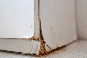 Corroded White Wooden Cabinet with Flaking Layers