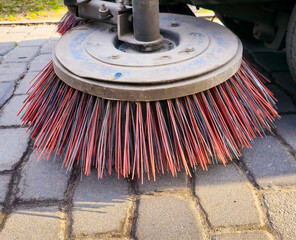 Close-up sweeper machine cleaning. Concept clean streets from debris.