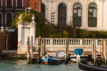 boats docked in front of historical building on grand canal in Venice, Italy 