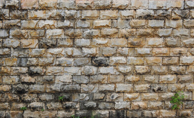 Naklejka na ściany i meble texture composed of yellow rustic stones with an irregular surface and evenly aligned