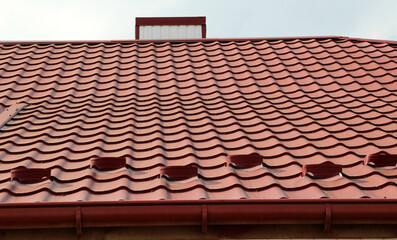 The roof of the house is covered with metal tiles