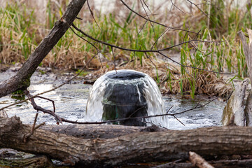 Drainage pipe connecting reservoirs during spring floods.