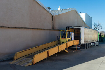 Mobile ramp used by the forklift to put the pallets inside the truck, truck loading.