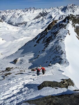 Mountaineering with crampons on ski boots. Ski tour on the fl&uuml;ela wisshorn in davos. Steep summit ascent. Swiss Alps. High quality photo