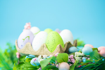 multi-colored painted Easter eggs on a blue background
