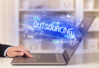 Closeup of businessman hands working on laptop