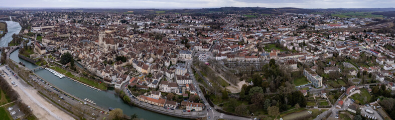 Fototapeta na wymiar Aerial around the old town of the city Dole in France on a cloudy afternoon in late winter