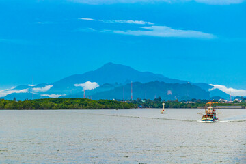 Tropical paradise turquoise water beach and limestone rocks Krabi Thailand.