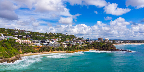 Aerial, drone view of the spectacular Sunshine Coast city near Brisbane. Beautiful buildings on the cliffs and golden sand beaches at sunrise. Landscape of Queensland, Australia