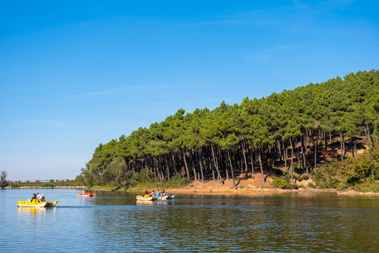 People having fun on the lake in the forest on pedal boats. Families on the pedalos boats. A fun activity on a sunny summer day. Aydos forest lake, Istanbul, Turkey