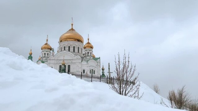 Belogorsky St. Nicholas Orthodox Missionary Monastery. Russia, Perm Krai, Belaya Gora. The temple on the hill in winter. Monastery on the background of snow. 4K