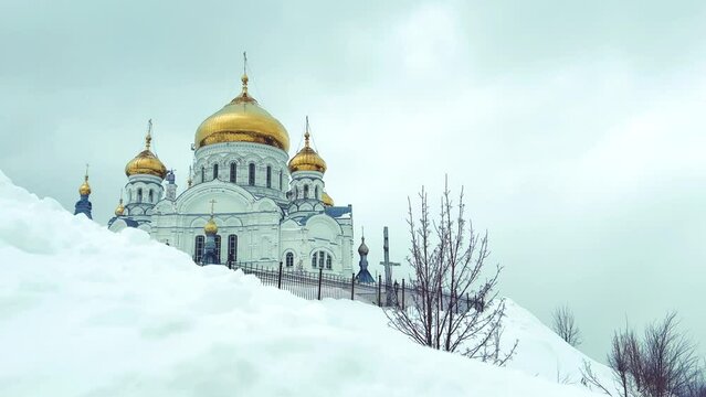 Belogorsky St. Nicholas Orthodox Missionary Monastery. Russia, Perm Krai, Belaya Gora. The temple on the hill in winter. Monastery on the background of snow. 4K