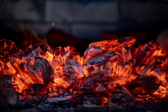 Flame of fire from hot burning coals in the fireplace. Heat from the oven. 